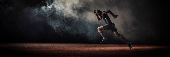 Man pushing off running with smoke in the background