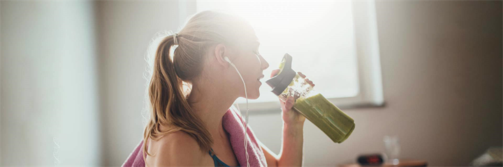 Woman drinking green juice