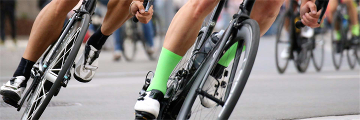 Photo of bicycle wheels with riders legs