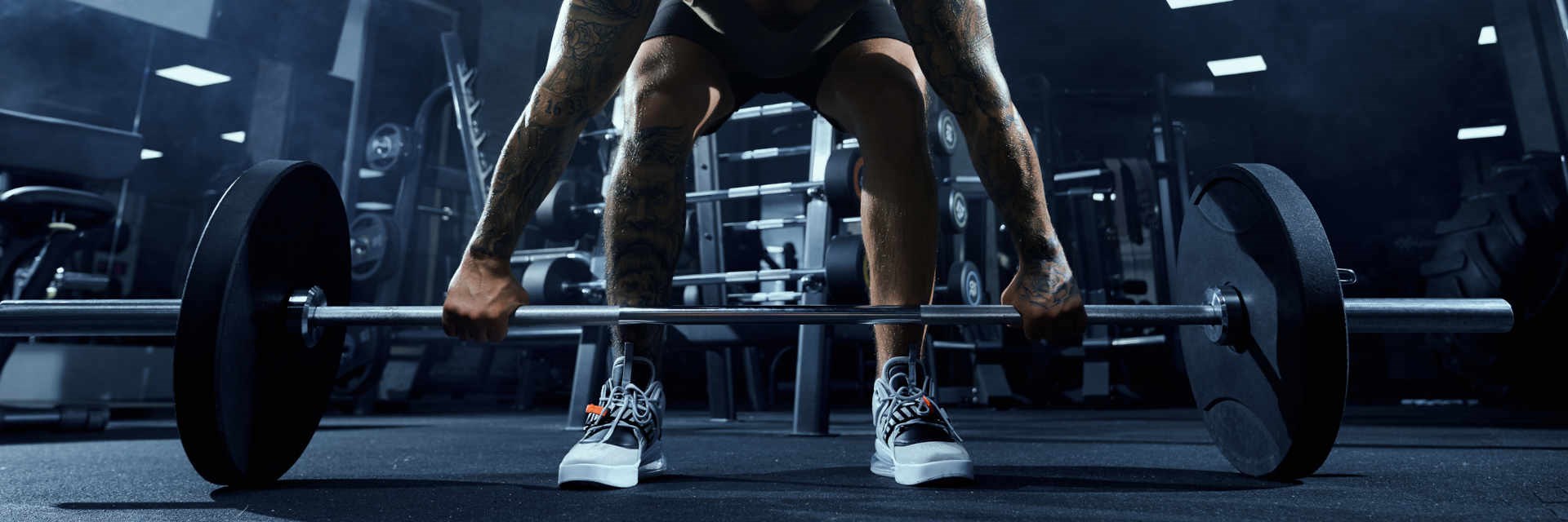 Man lifting barbell weight in gym